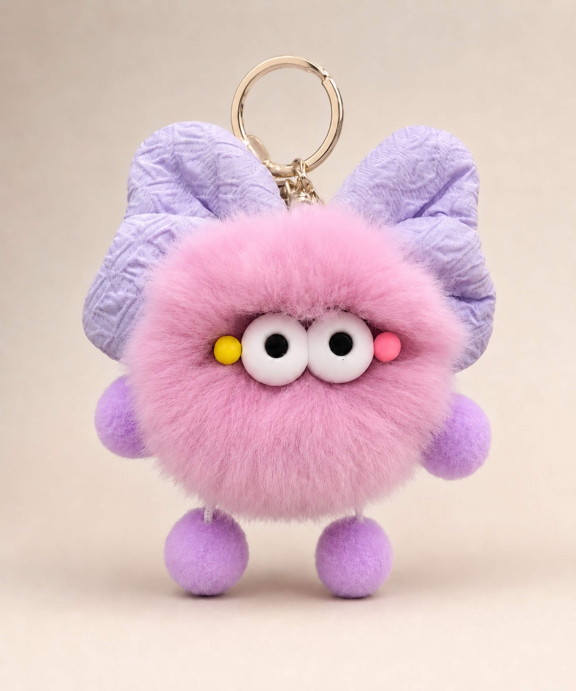 Purple fluffy bow plush keychain with lavender bow-style ears and soft furry texture