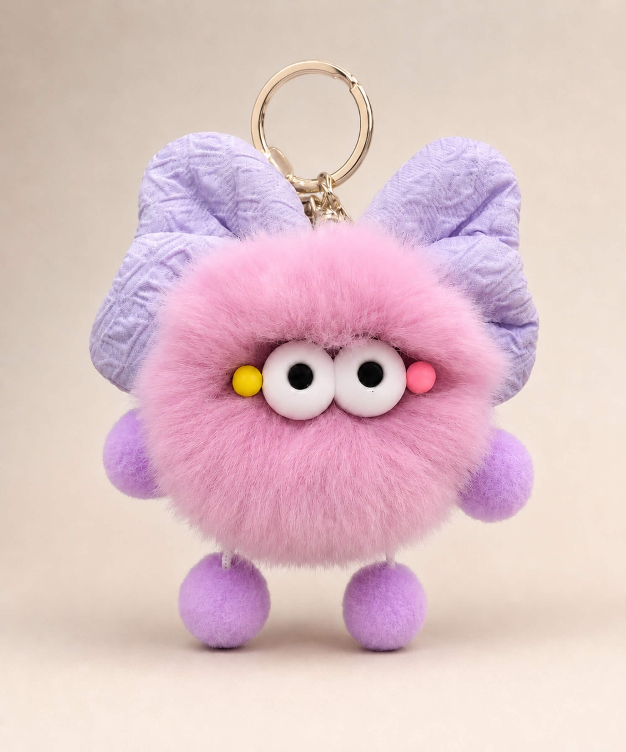 Purple fluffy bow plush keychain with lavender bow-style ears and soft furry texture