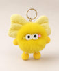 Yellow fluffy bow plush keychain with cute wide-eye detail and gold-tone hardware