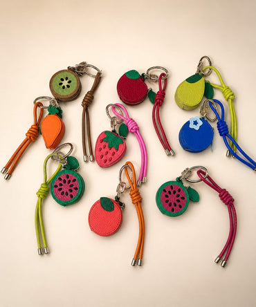 Fruit coin purse keychains in assorted colourful PU leather-style pouch designs with matching straps