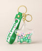 Good Luck star liquid keychain with pastel beads, green strap and gold hardware