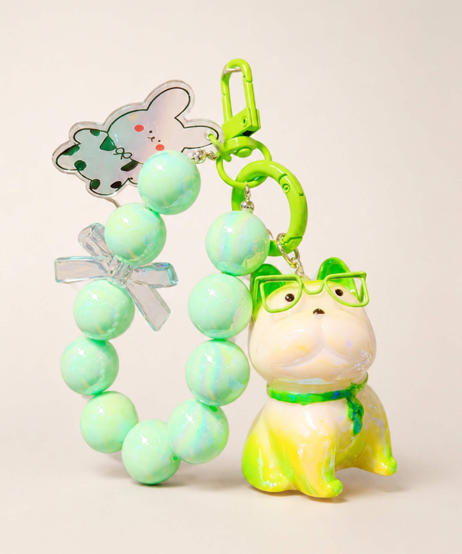 Green French Bulldog beaded keychain with glasses, bead loop and bunny charm on a neutral background