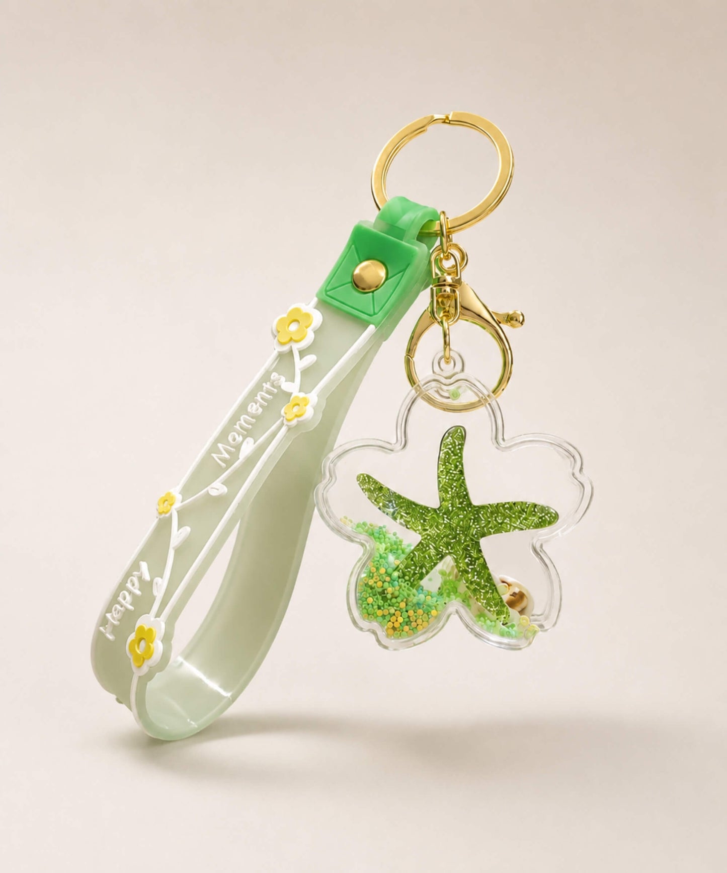 Green starfish liquid keychain with green glitter, shell detail, floral strap and gold hardware