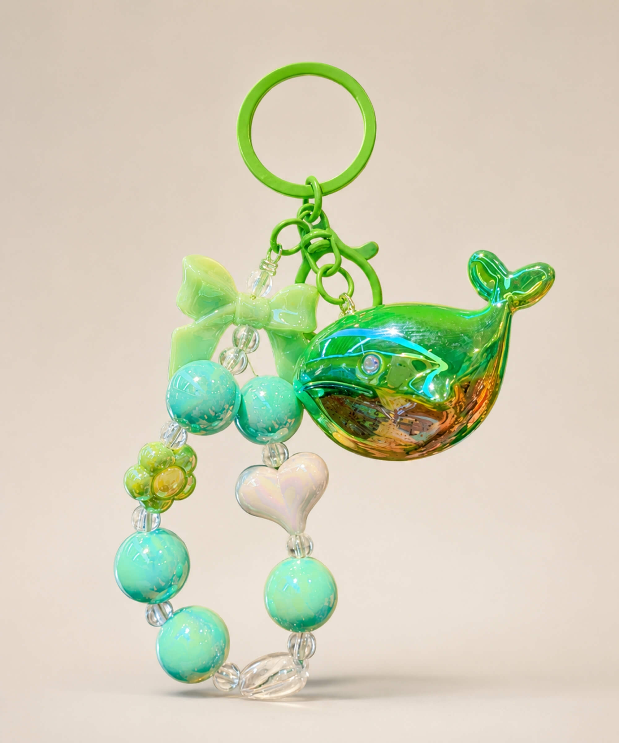 Green whale beaded keychain with glossy green beads, bow charm and heart detail