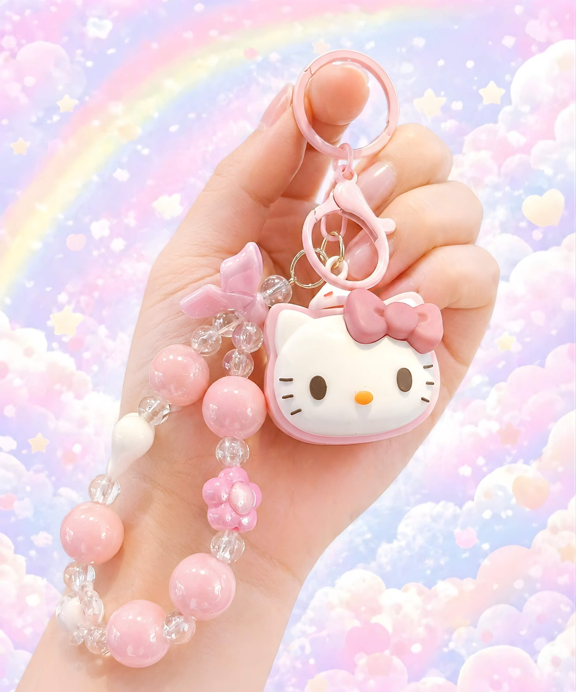 Hello Kitty pink beaded keychain held in hand with a pastel rainbow background