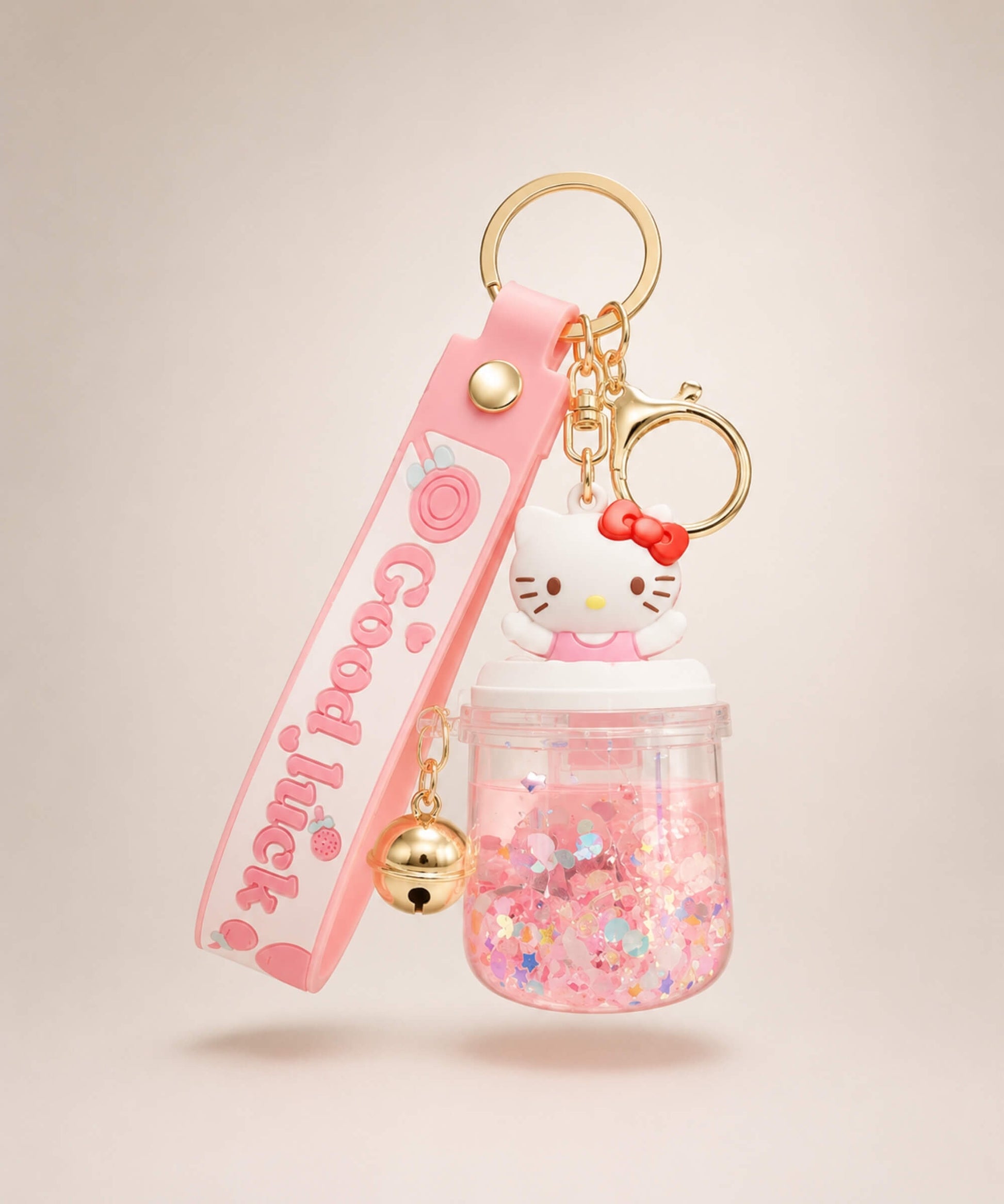 Hello Kitty sparkle jar liquid keychain with pink glitter, gold bell, pink strap and gold hardware