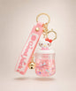 Hello Kitty sparkle jar liquid keychain with pink glitter, gold bell, pink strap and gold hardware