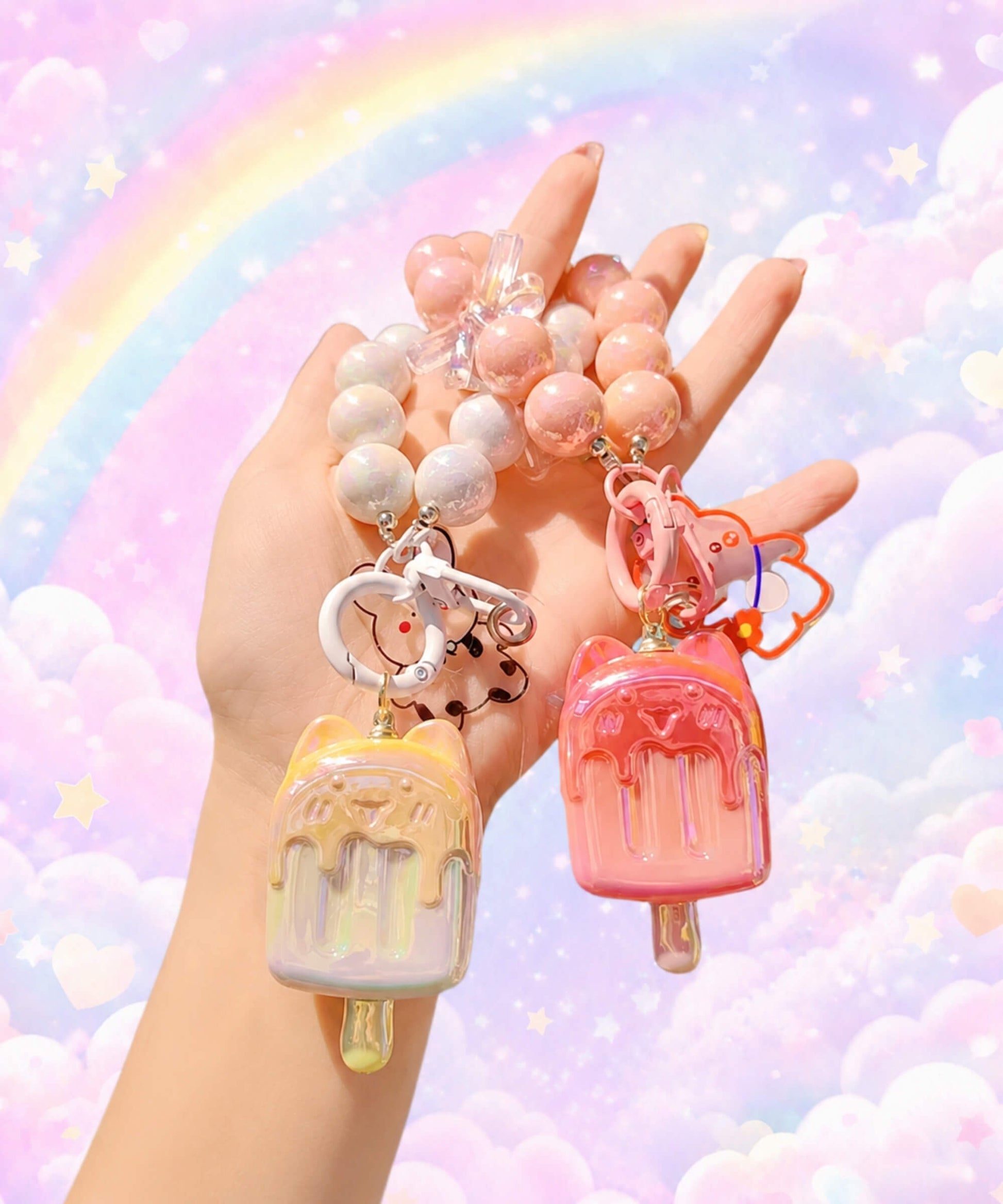 Ice cream beaded keychains in assorted colours held in hand with a pastel rainbow background