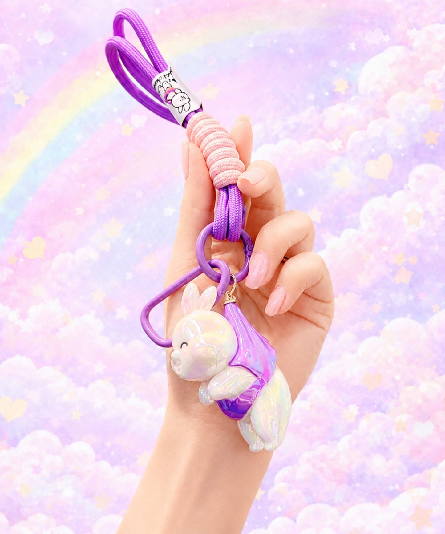 Purple iridescent bunny resin keychain held in hand