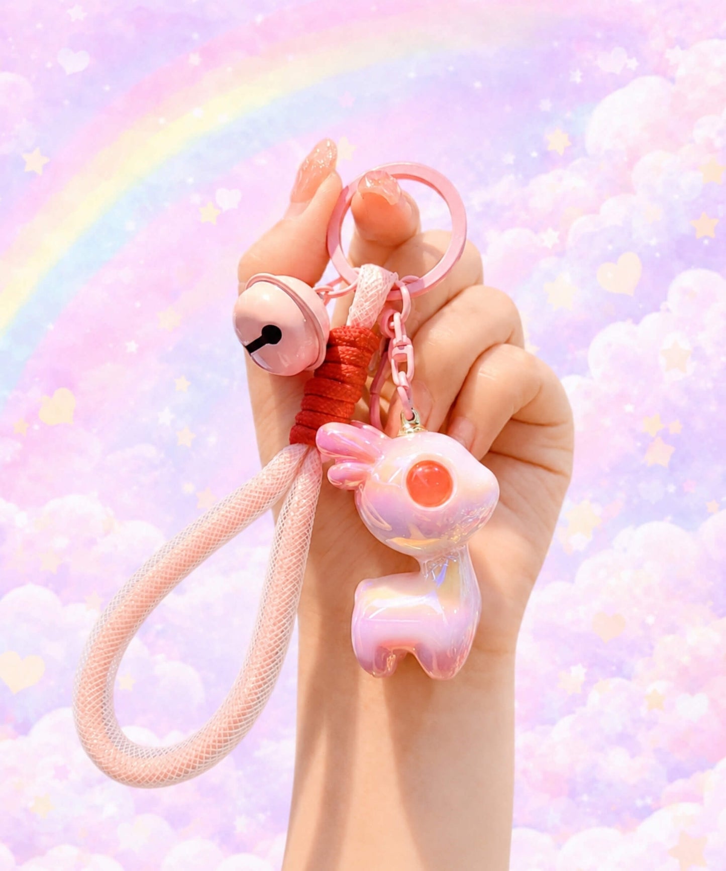 Pink iridescent deer resin keychain held in hand