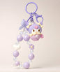 Kuromi purple beaded keychain with heart, flower and butterfly charm details on a neutral background