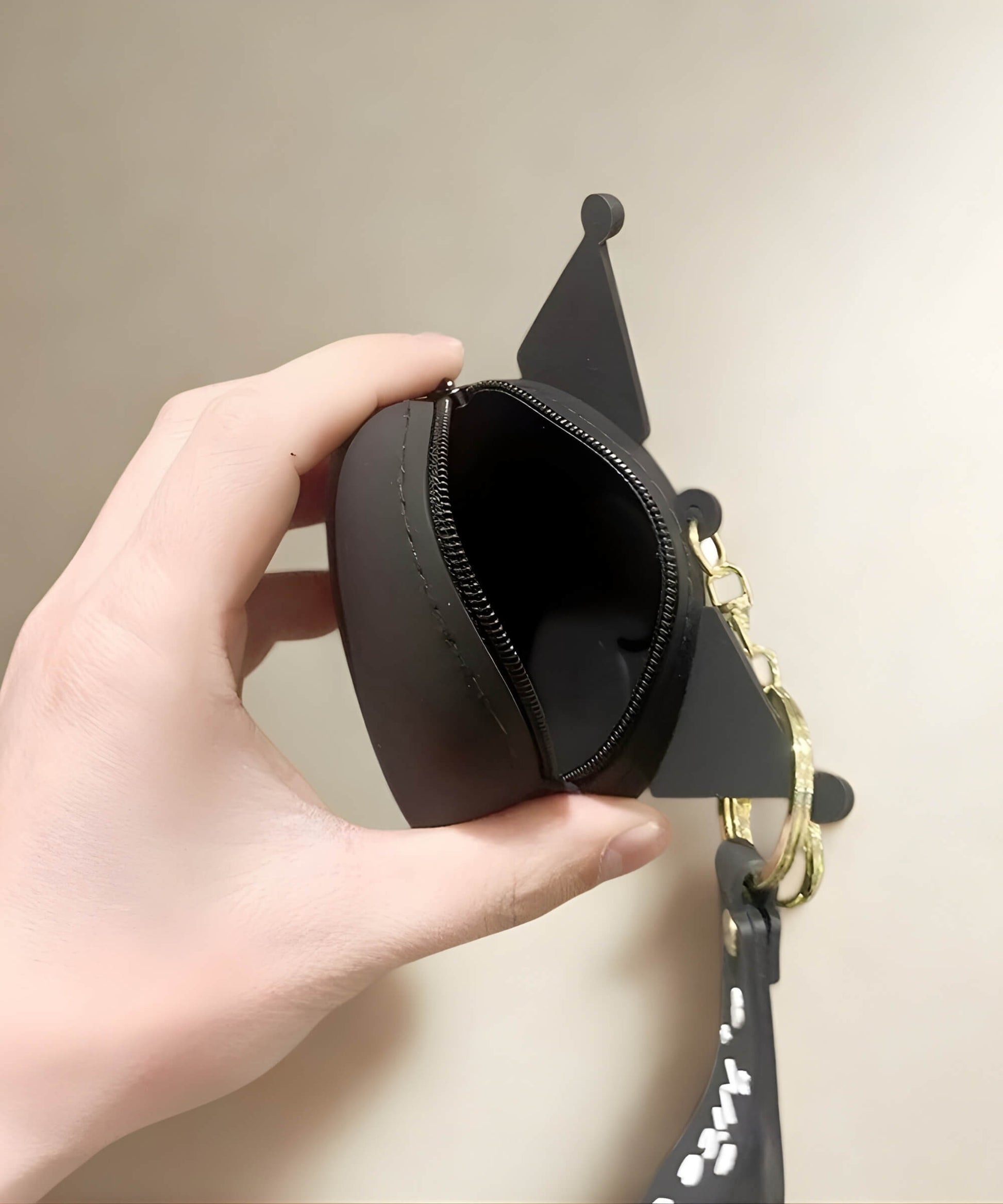 Kuromi silicone coin purse keychain showing zipper opening and storage space