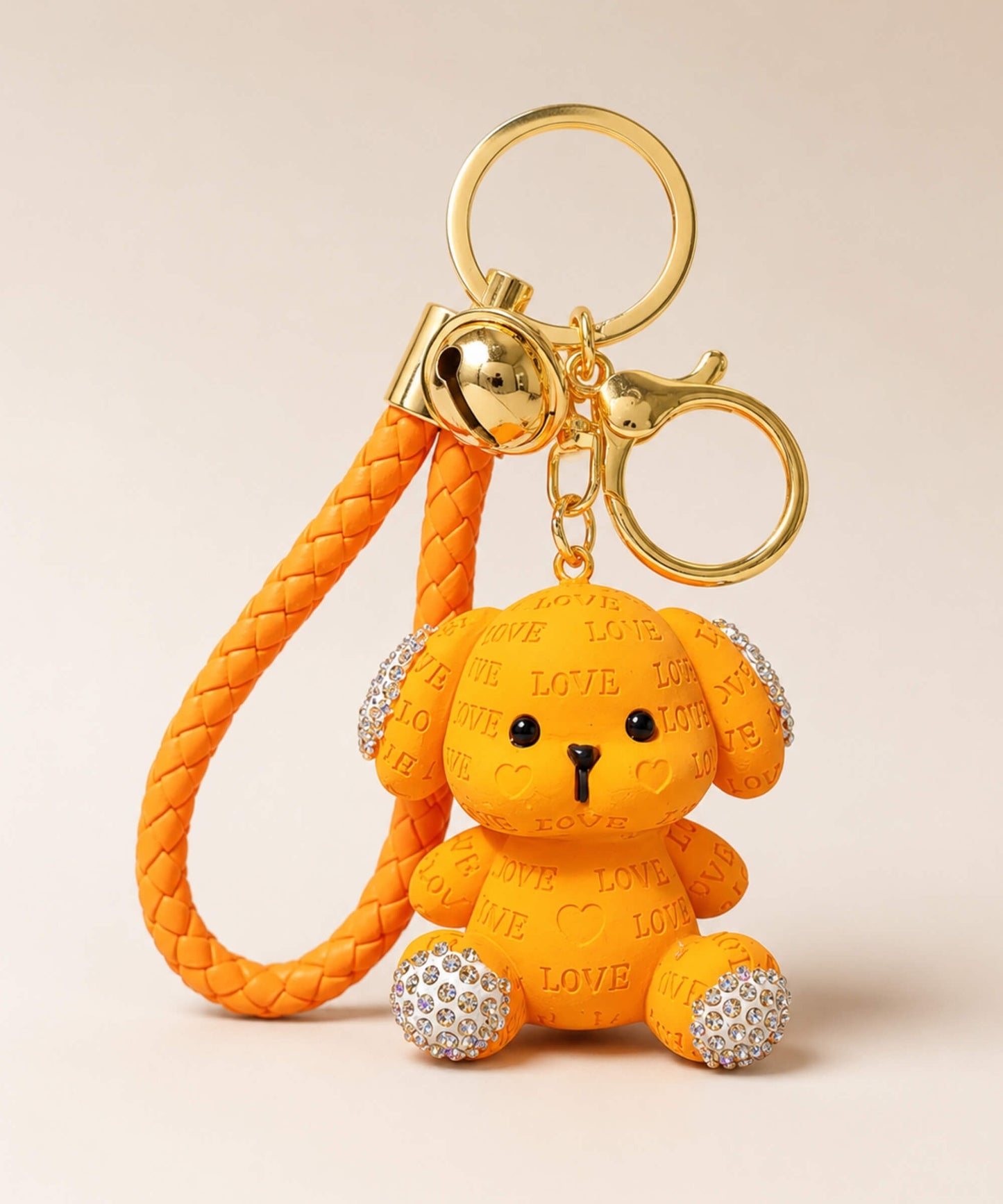 Orange love puppy resin keychain on a neutral background.