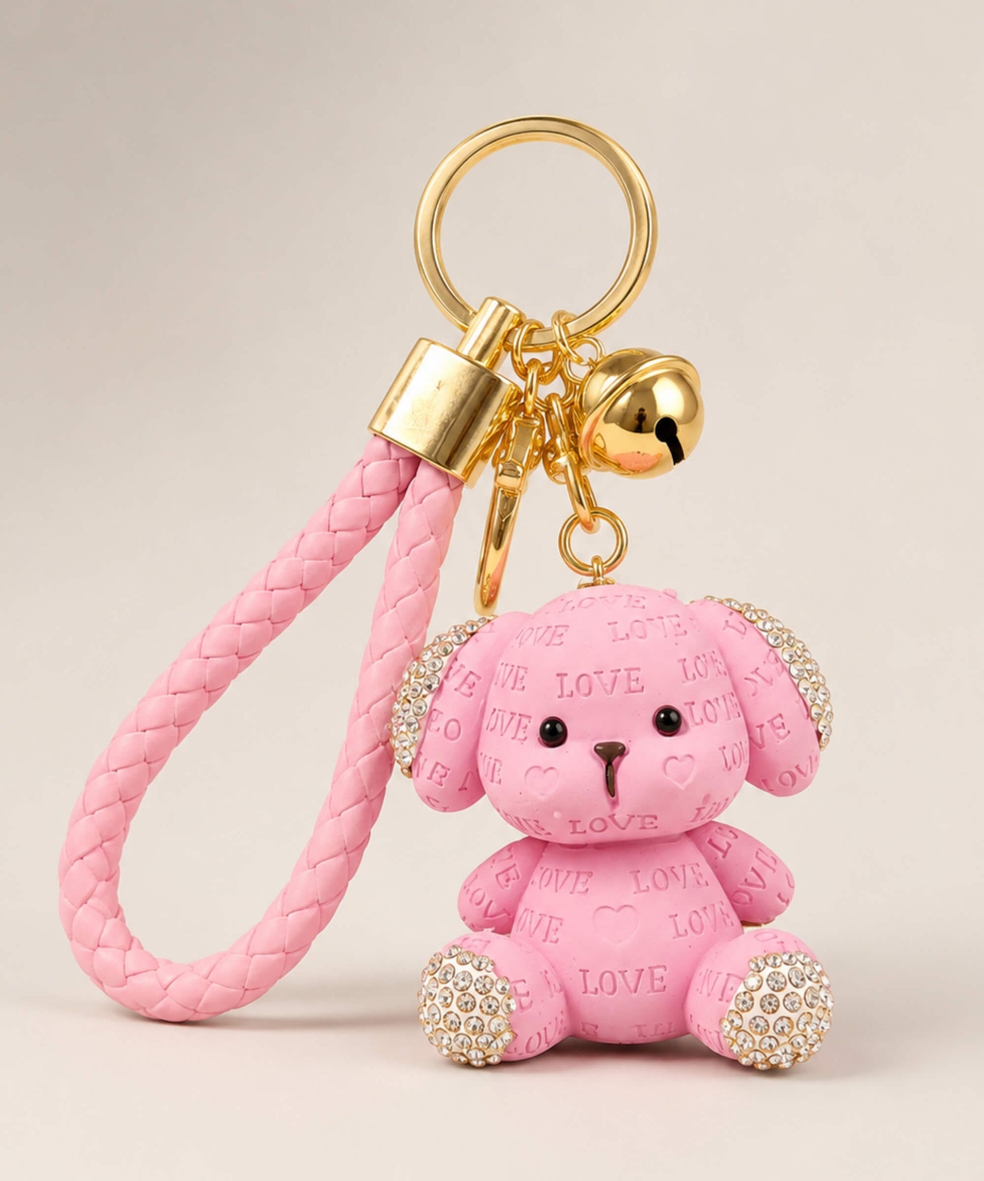 Pink love puppy resin keychain on a neutral background.