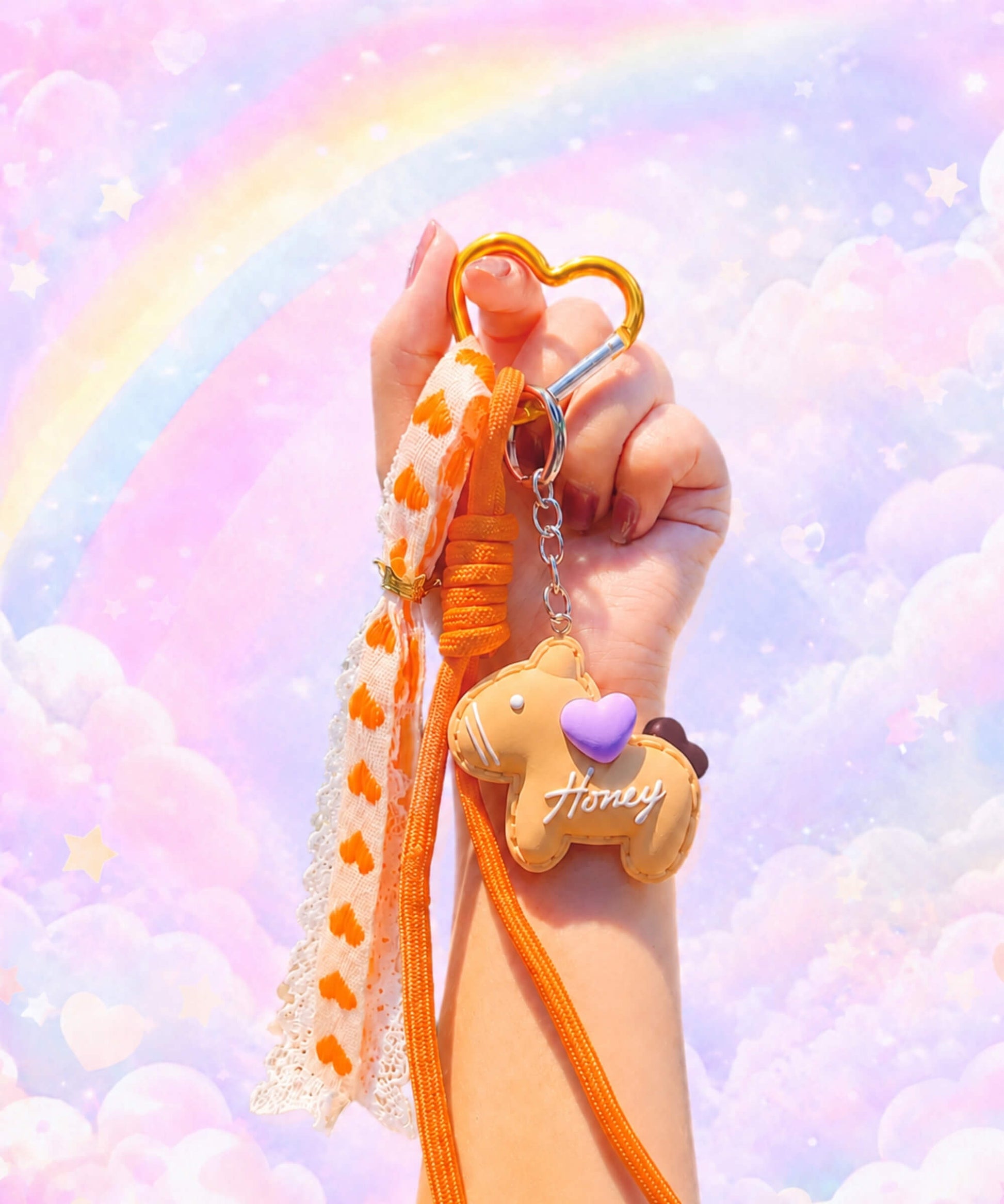 Orange pony phone charm held in hand