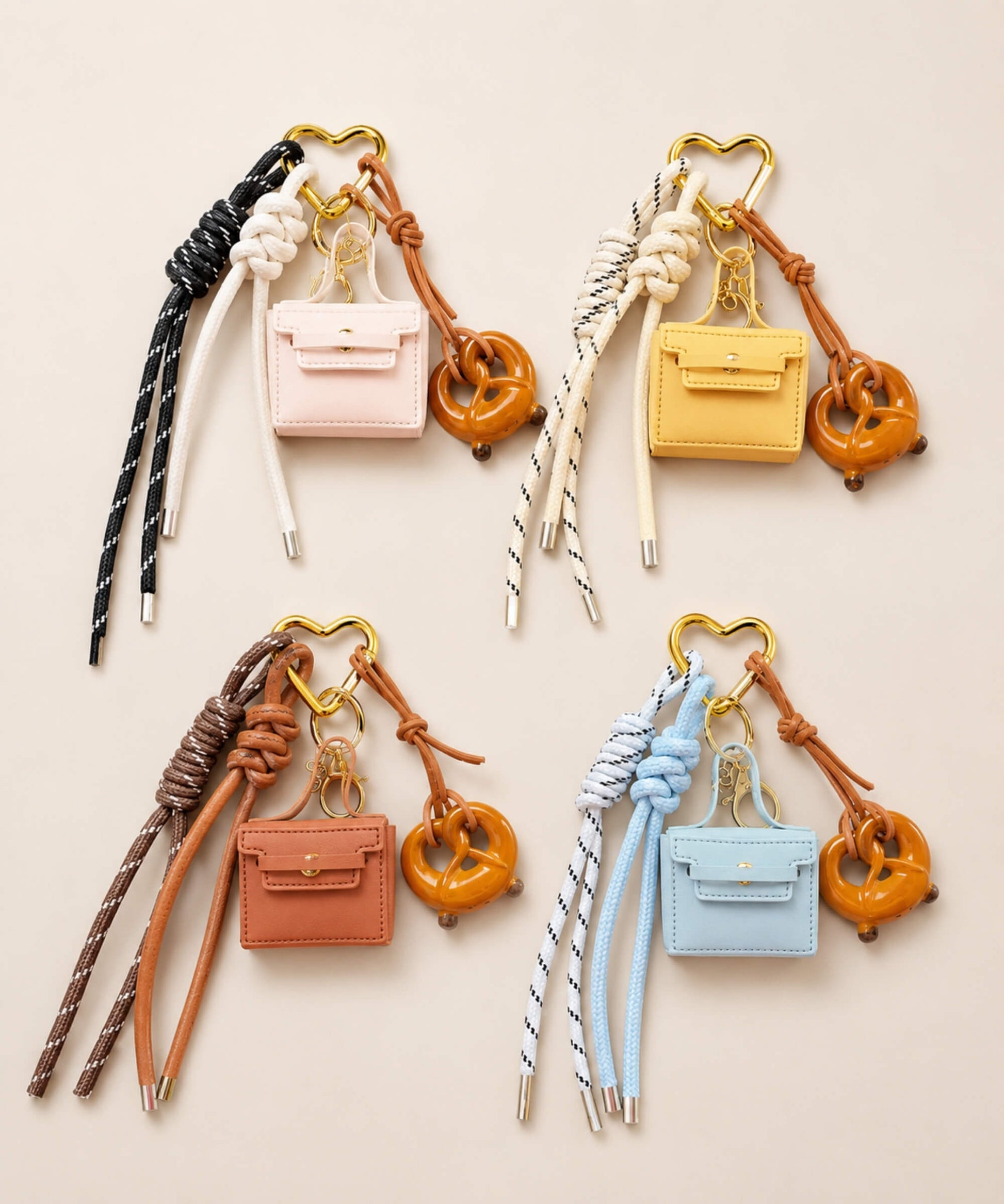 Mini PU leather coin purse keychains in pink, yellow, brown and blue with pretzel charms and rope straps