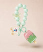 Mint ice cream beaded keychain with green beads and bear charm on a neutral background