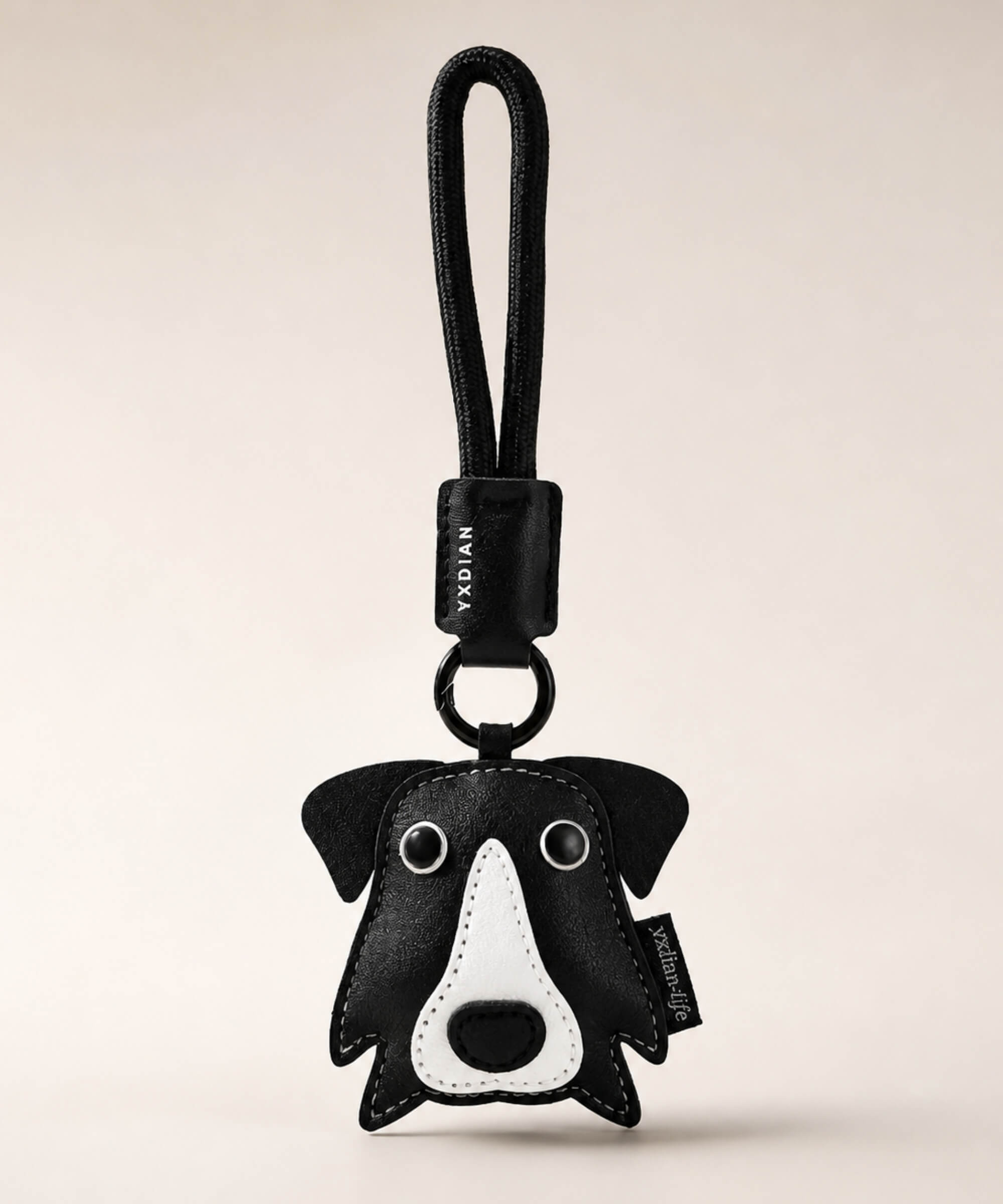 Border Collie pet face PU leather bag charm keychain on a neutral background.