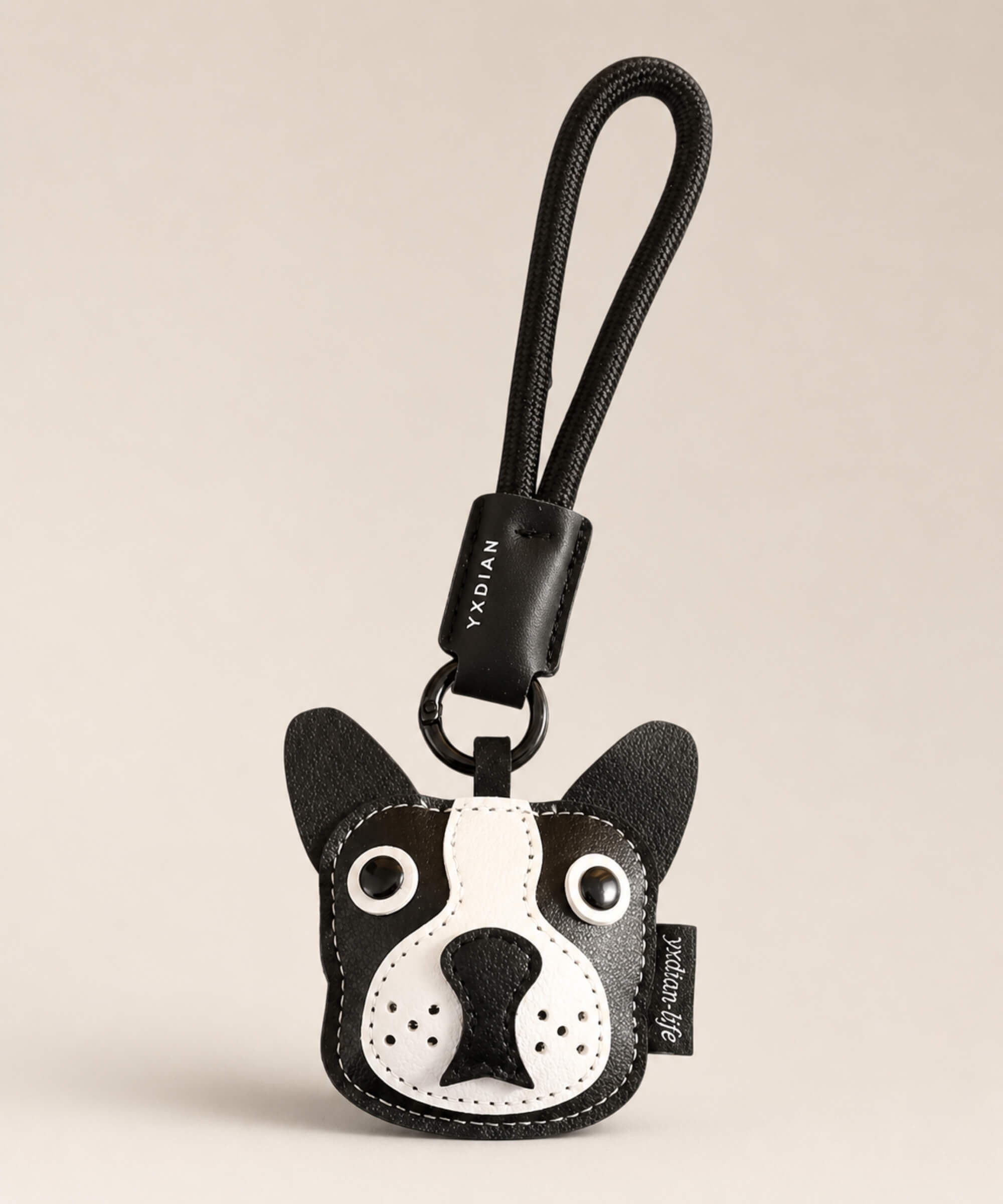 Bulldog pet face PU leather bag charm keychain on a neutral background.