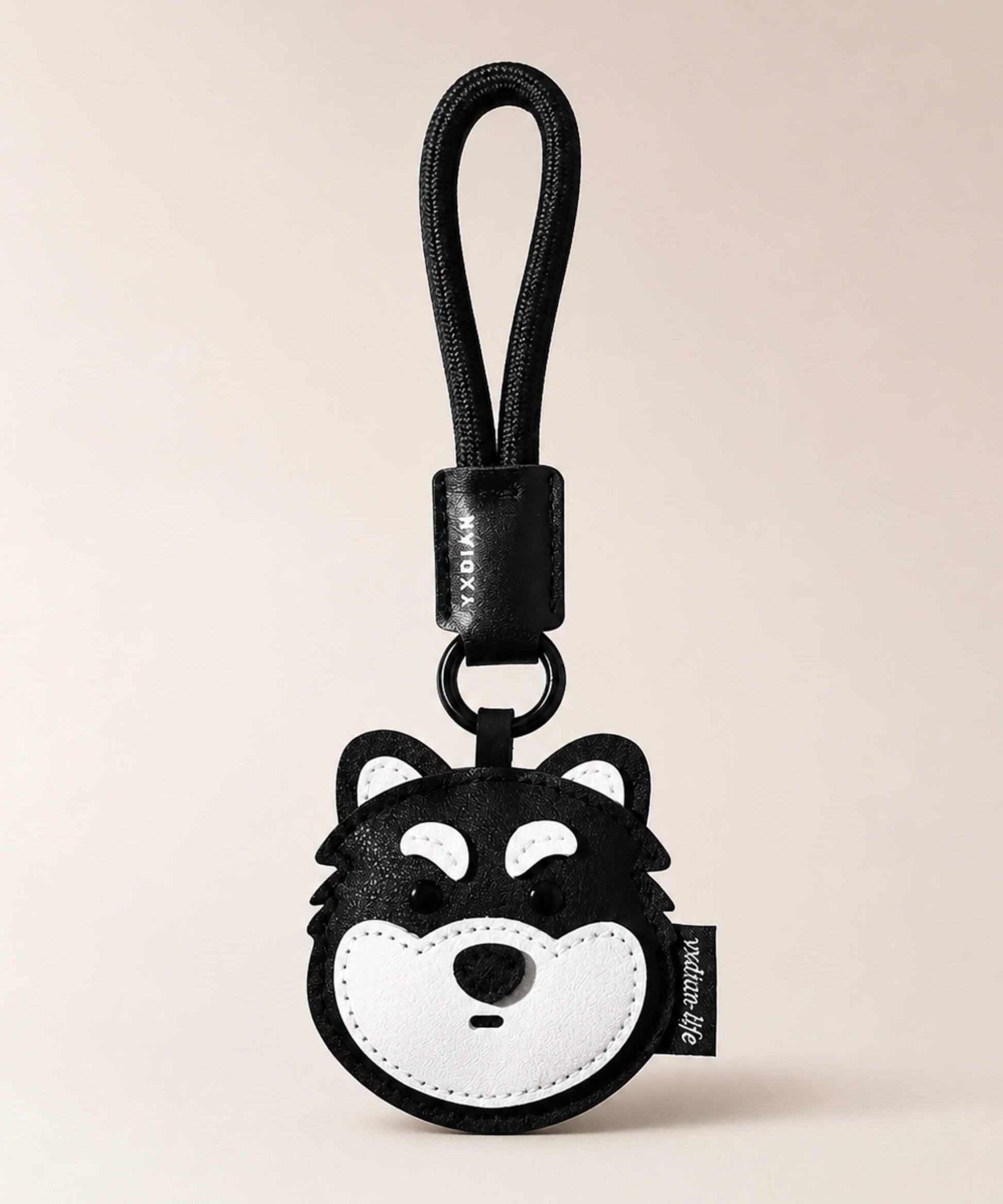 Husky pet face PU leather bag charm keychain on a neutral background.