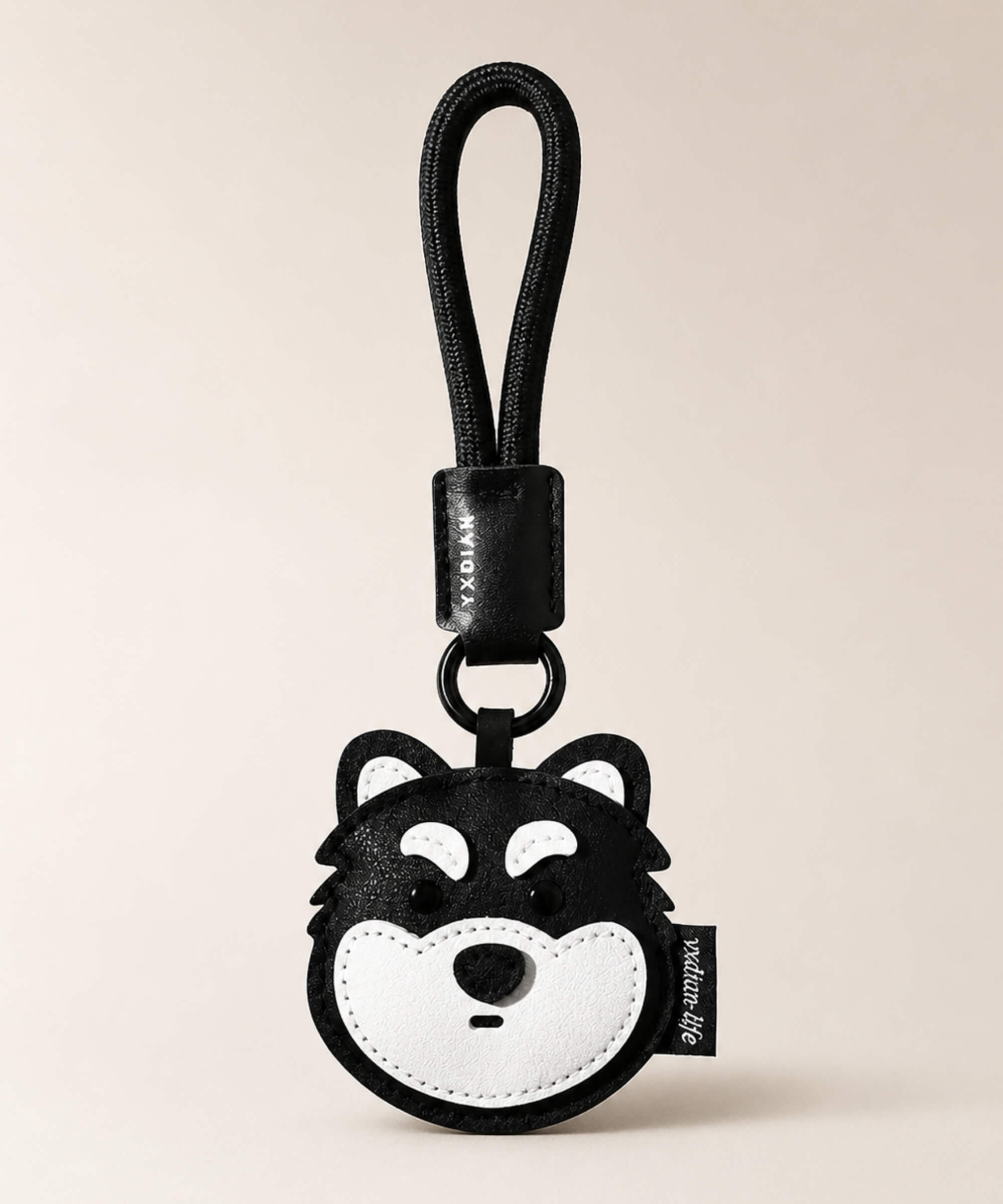 Husky pet face PU leather bag charm keychain on a neutral background.
