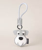 Schnauzer pet face PU leather bag charm keychain on a neutral background.