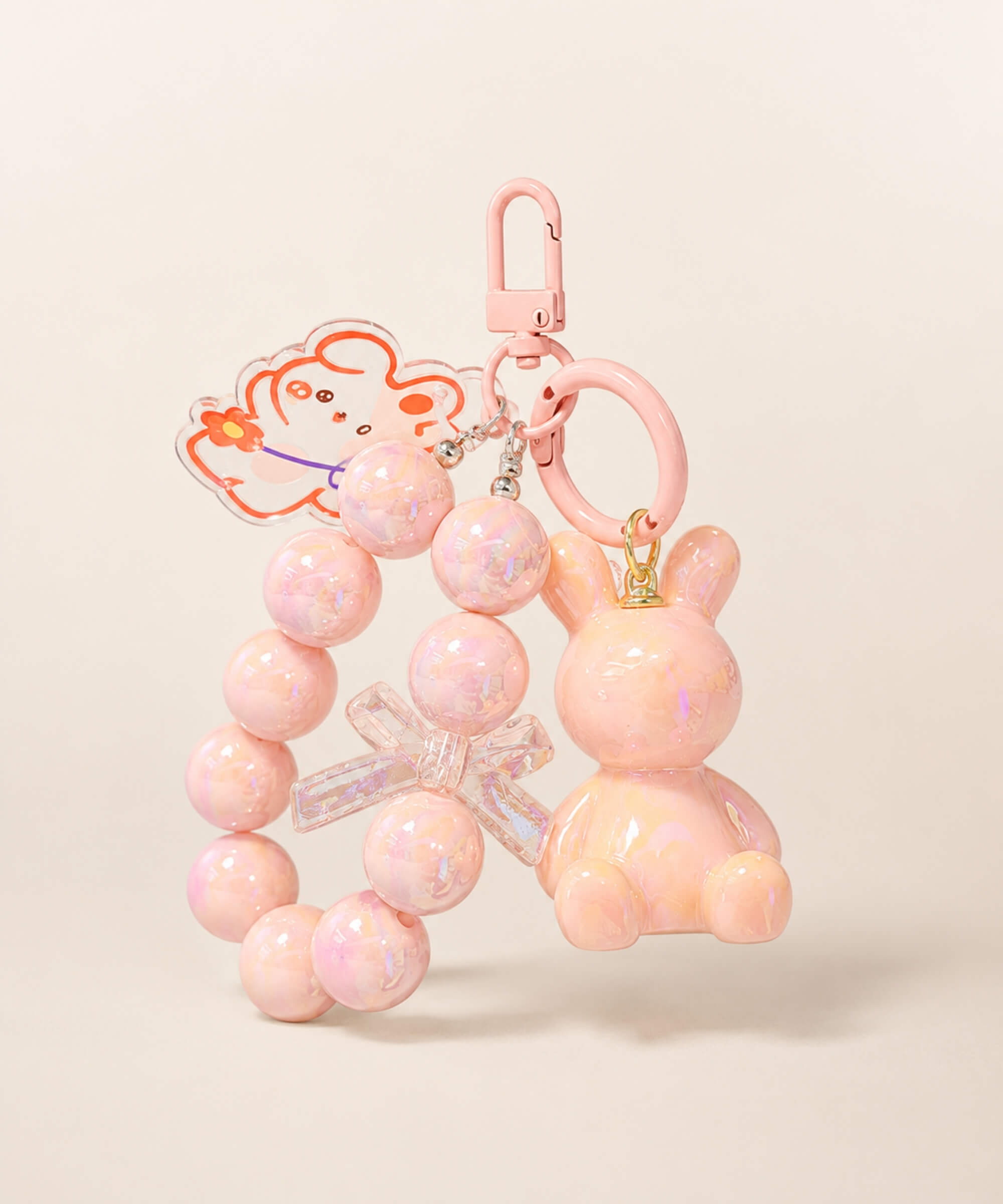 Pink bunny beaded keychain with rabbit charm and bow detail on a neutral background