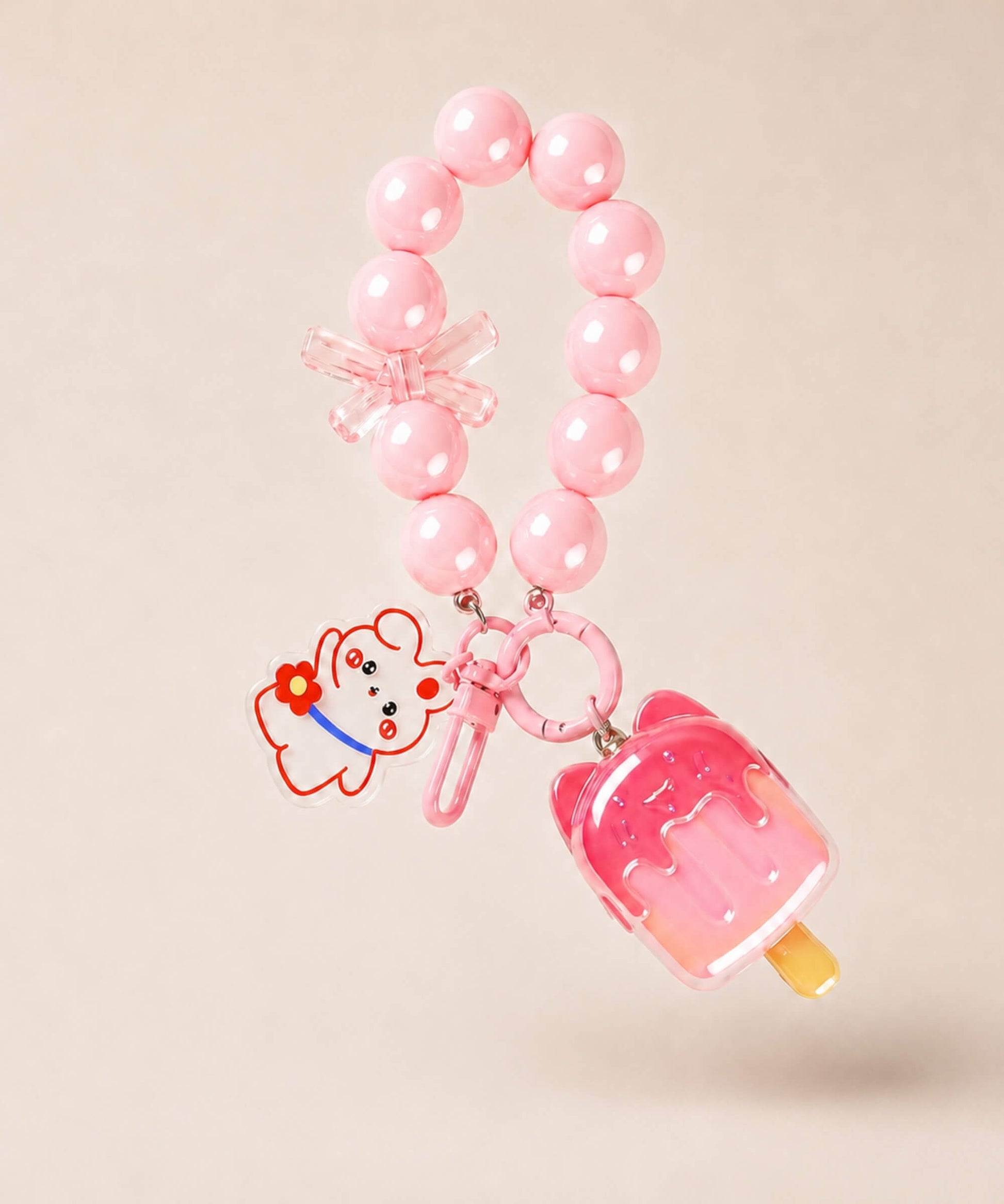 pink beads and bear charm on a neutral background