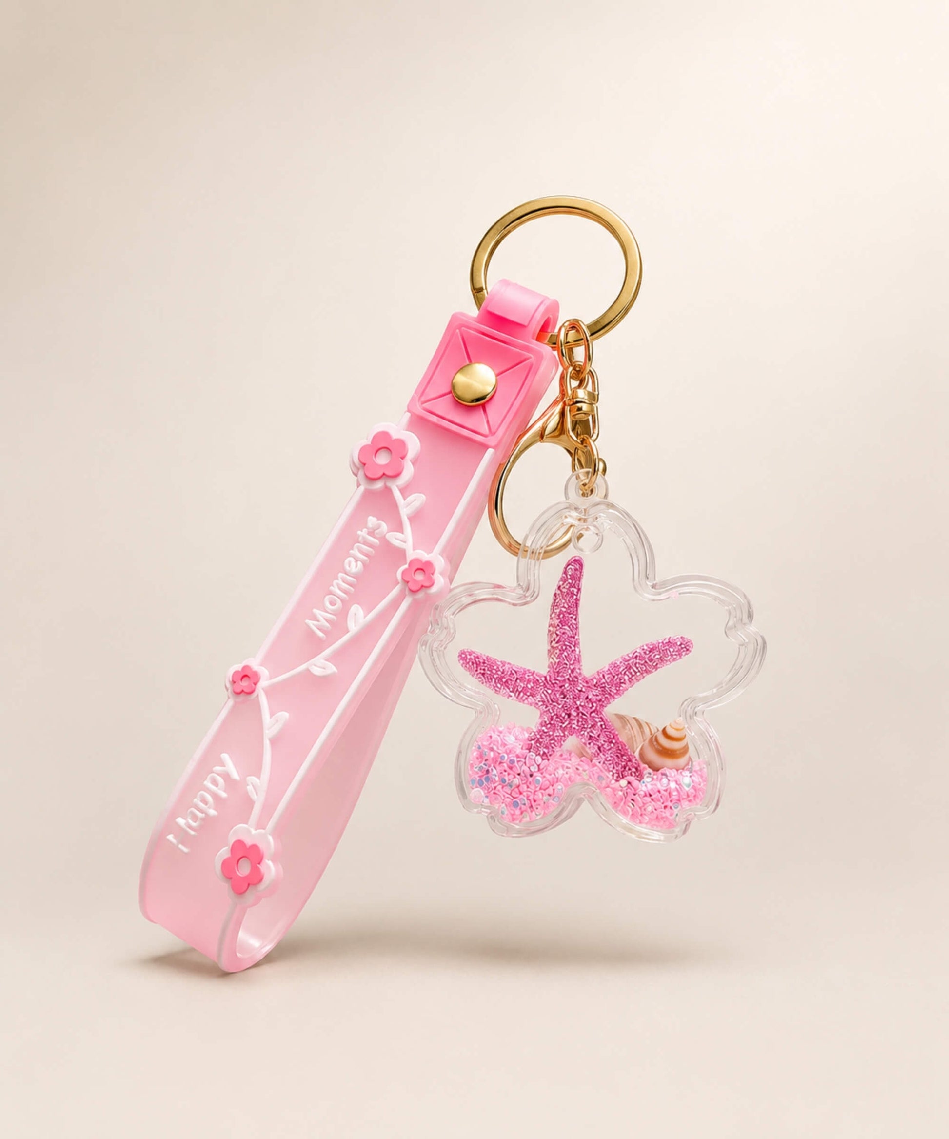 Pink starfish liquid keychain with pink glitter, shell detail, floral strap and gold hardware