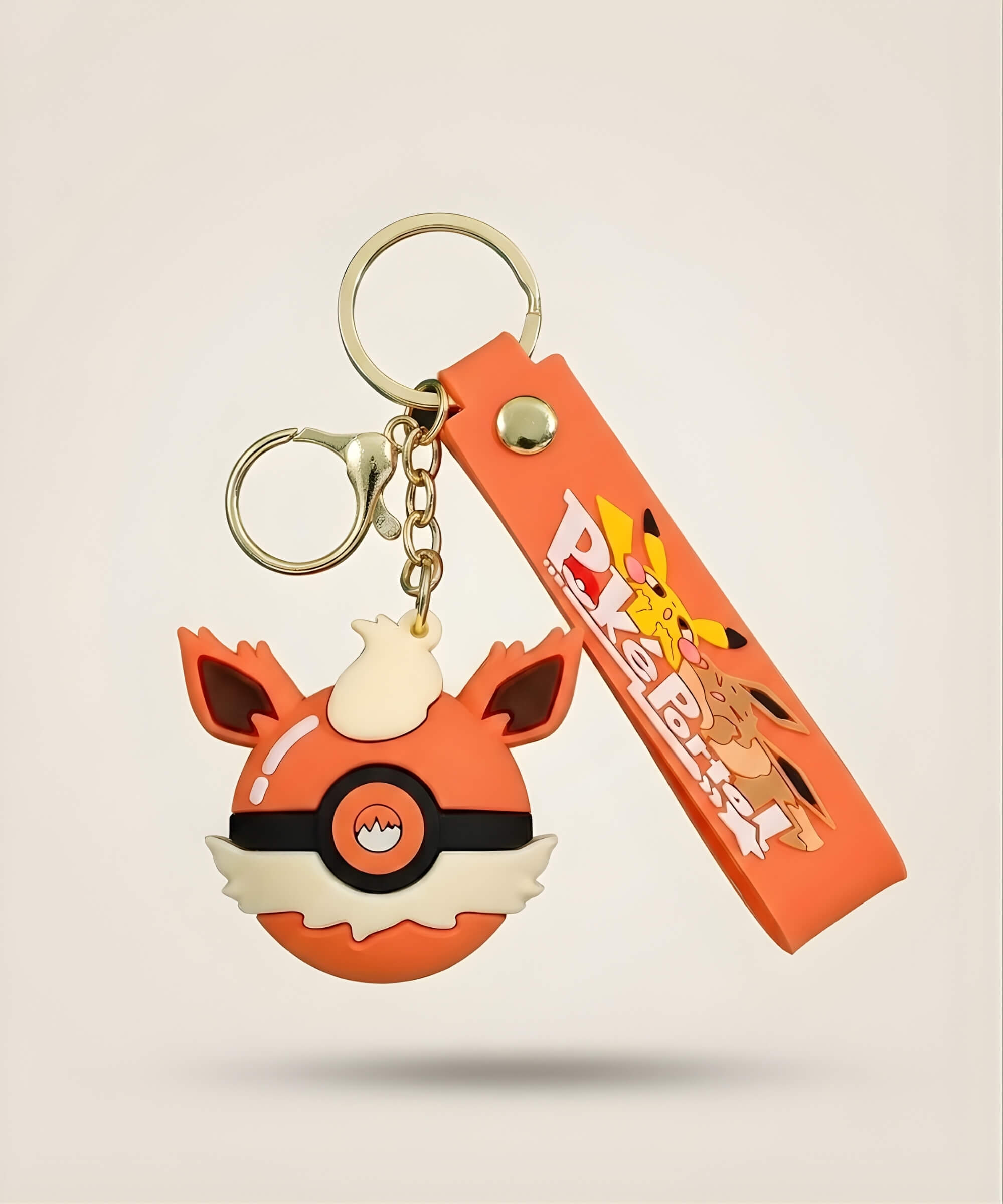 Fire style Poke Ball-inspired strap keychain with orange 3D charm, matching wrist strap and gold-tone hardware