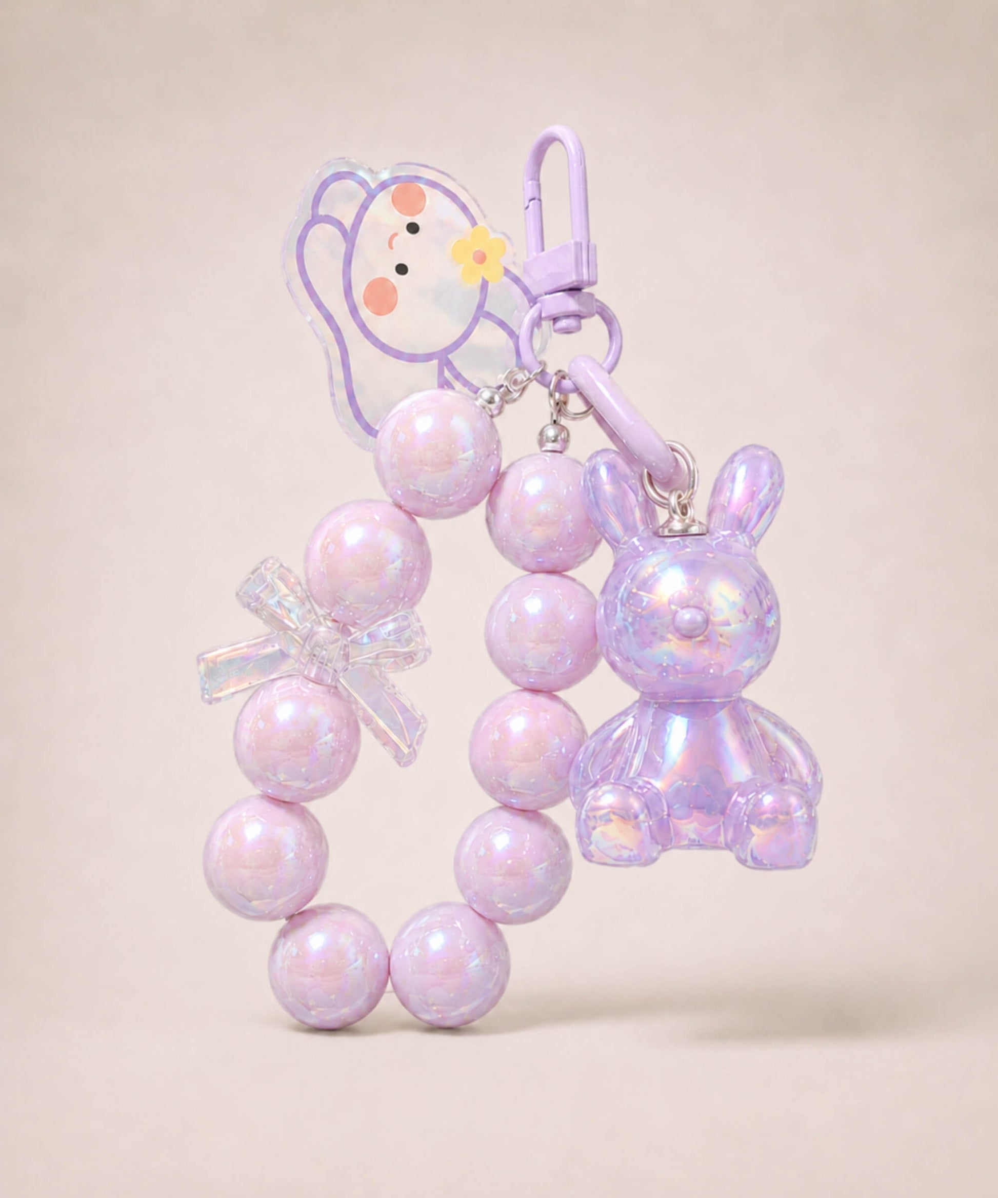 Purple bunny beaded keychain with iridescent rabbit charm and bow detail on a neutral background