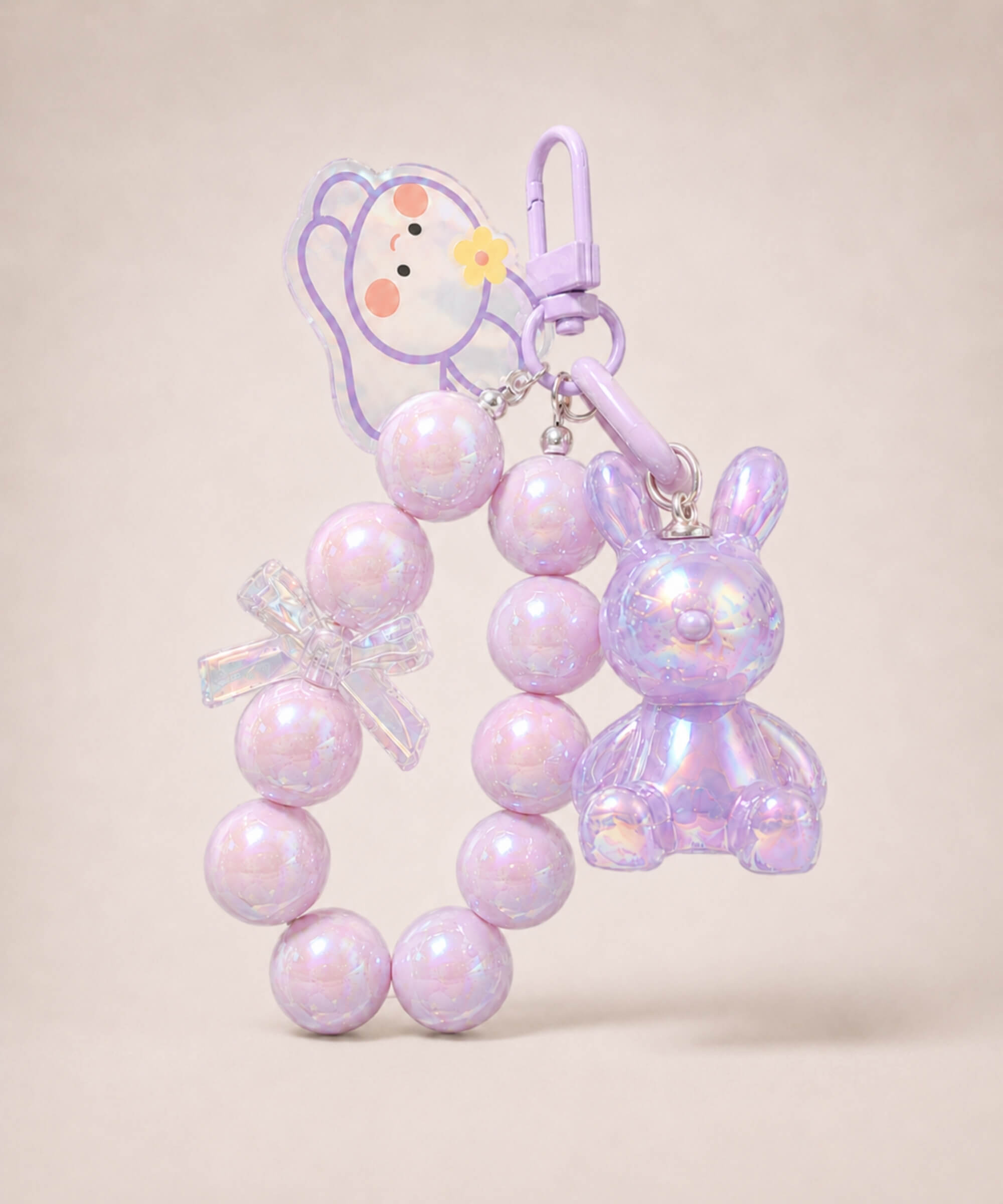 Purple bunny beaded keychain with iridescent rabbit charm and bow detail on a neutral background
