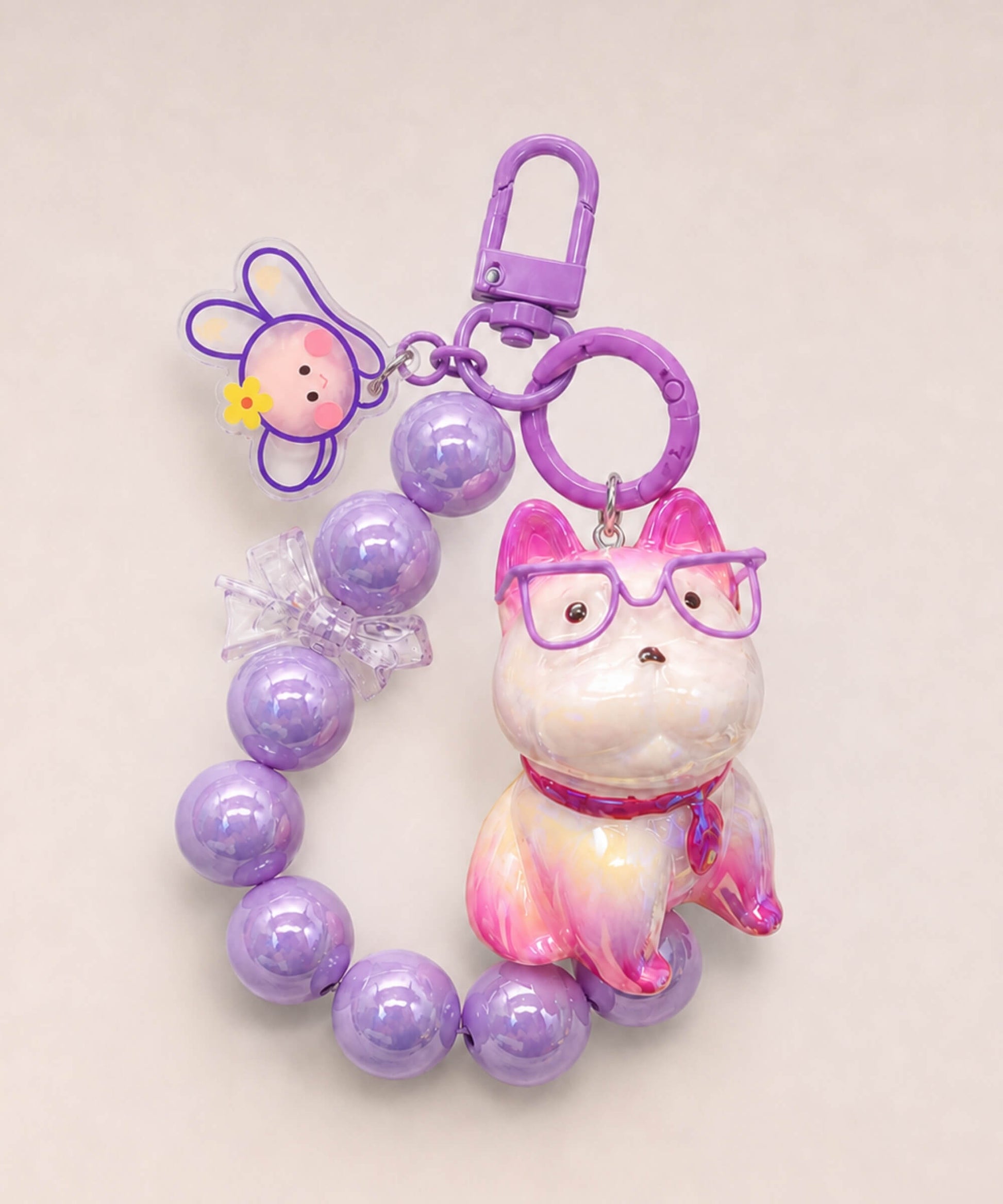Purple French Bulldog beaded keychain with glasses, bead loop and bunny charm on a neutral background