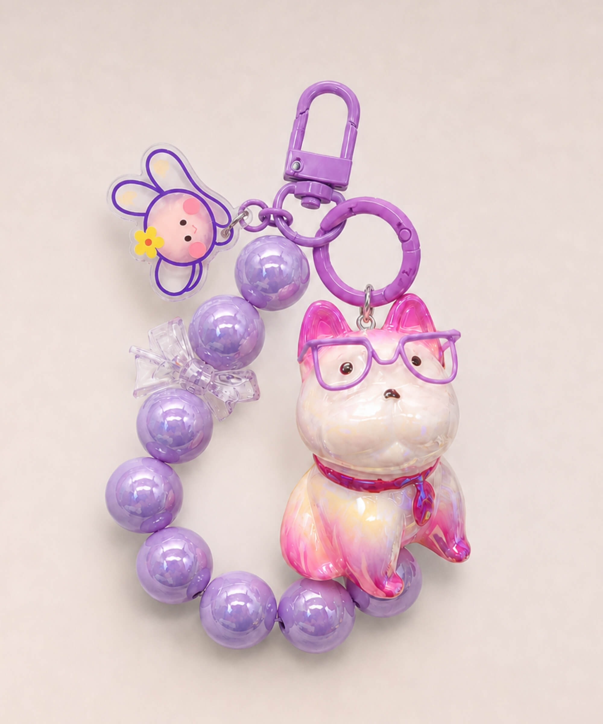 Purple French Bulldog beaded keychain with glasses, bead loop and bunny charm on a neutral background