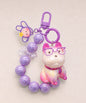 Purple French Bulldog beaded keychain with glasses, bead loop and bunny charm on a neutral background