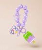 Purple ice cream beaded keychain with purple beads and bunny charm on a neutral background