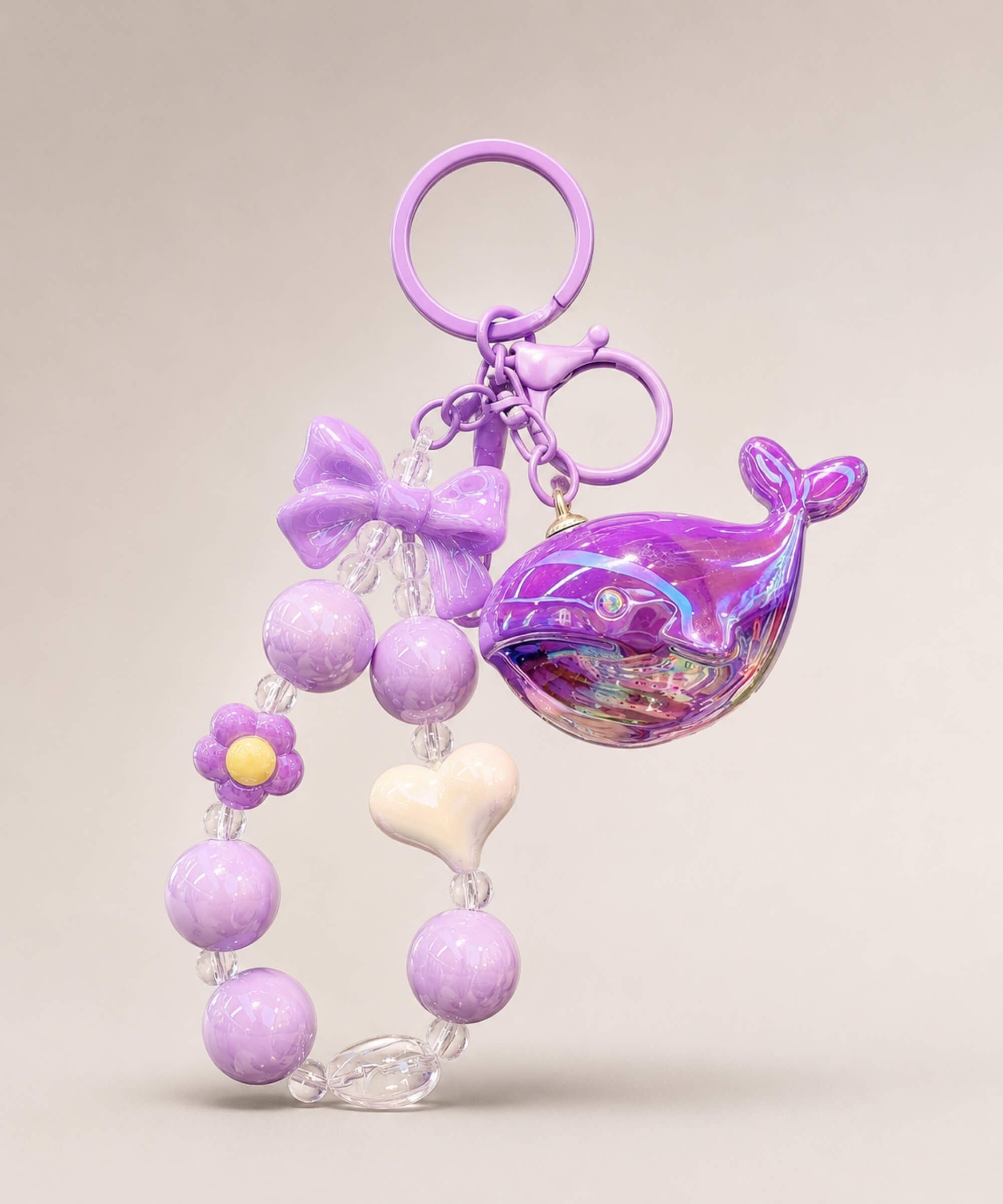 Purple whale beaded keychain with glossy purple beads, bow charm and heart detail