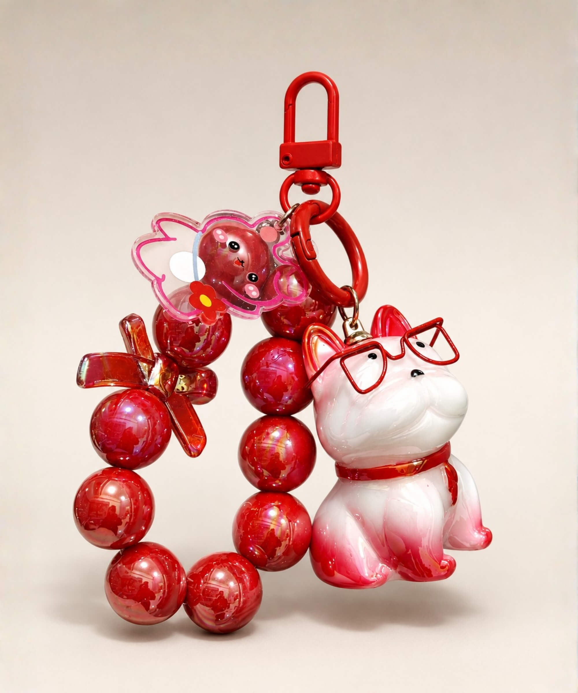 Red French Bulldog beaded keychain with glasses, bead loop and bear charm on a neutral background