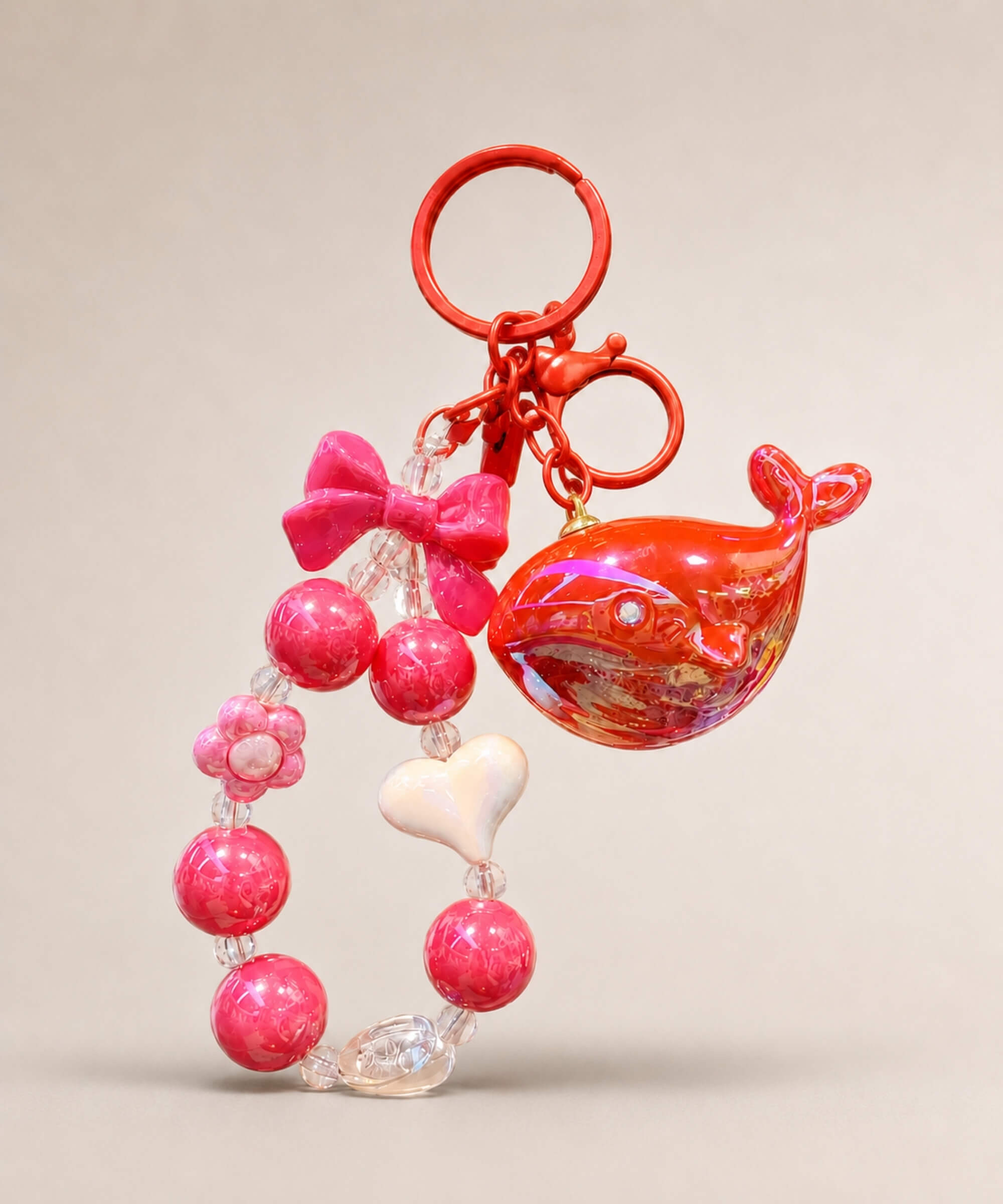 Red whale beaded keychain with glossy red beads, bow charm and heart detail