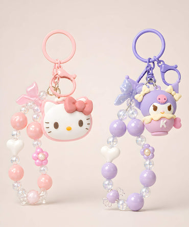 Hello Kitty and Kuromi beaded keychains in pink and purple colour options on a neutral background