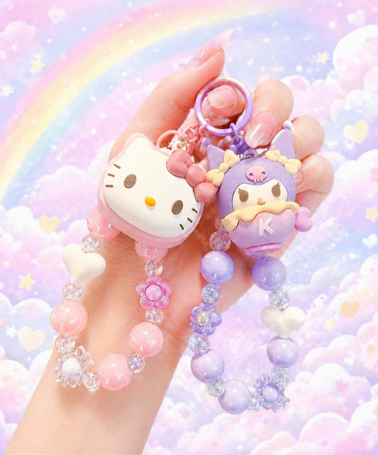 Hello Kitty and Kuromi beaded keychains held together with a pastel rainbow background