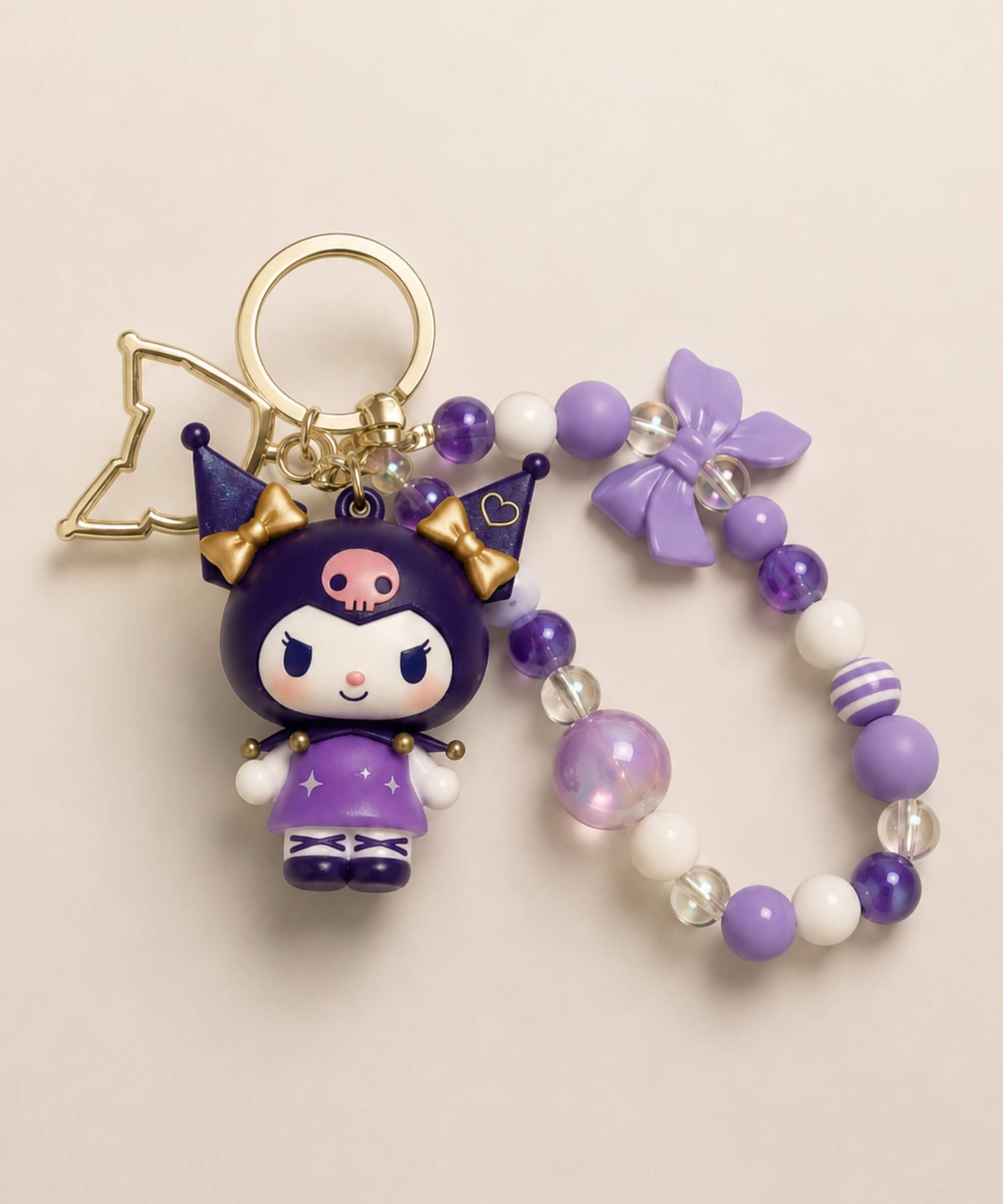 Purple Kuromi magic Sanrio beaded keychain with purple beads, bow detail and gold-tone hardware