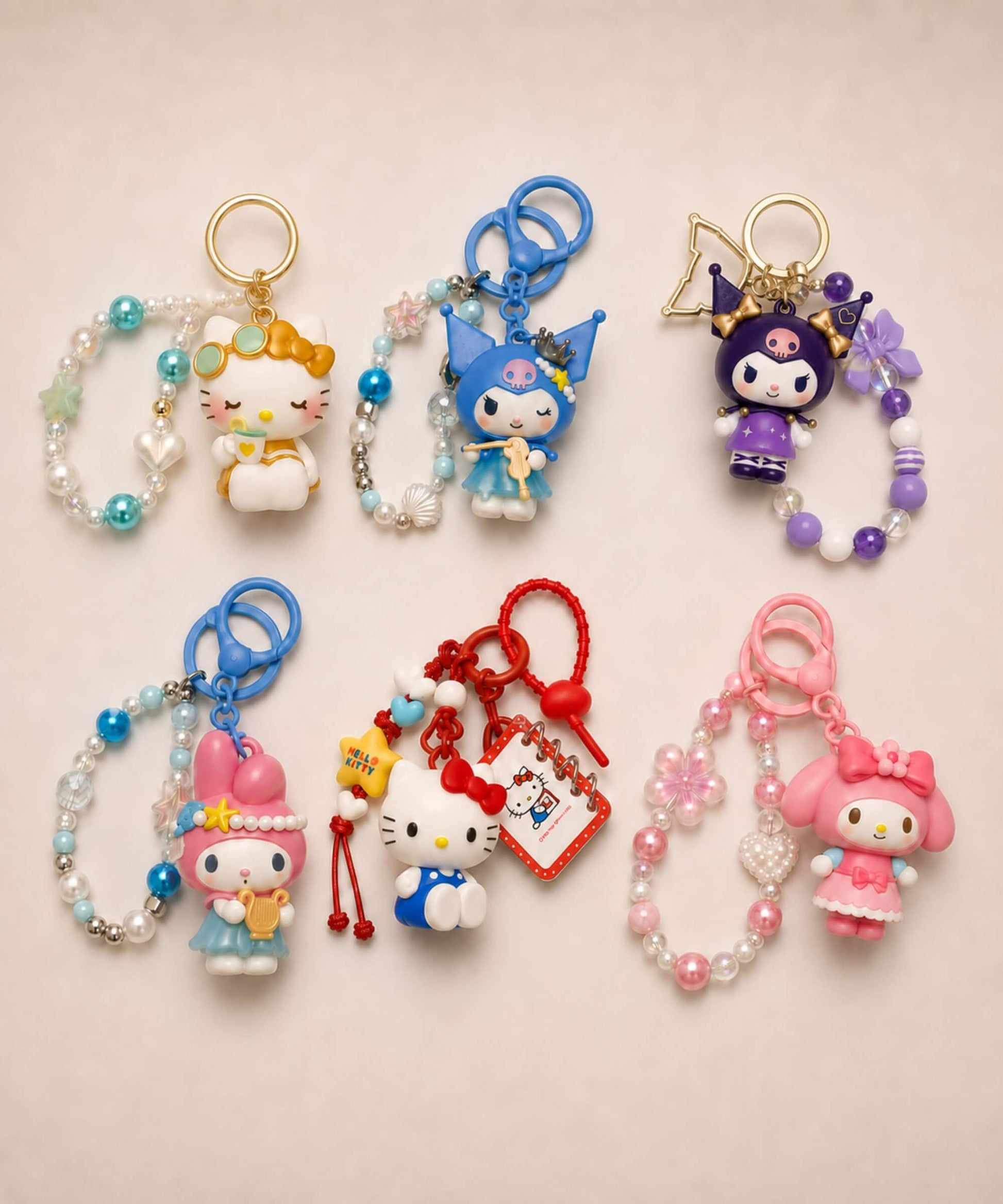Sanrio beaded keychains featuring Hello Kitty, My Melody and Kuromi with tea, violin, accordion, princess and book designs