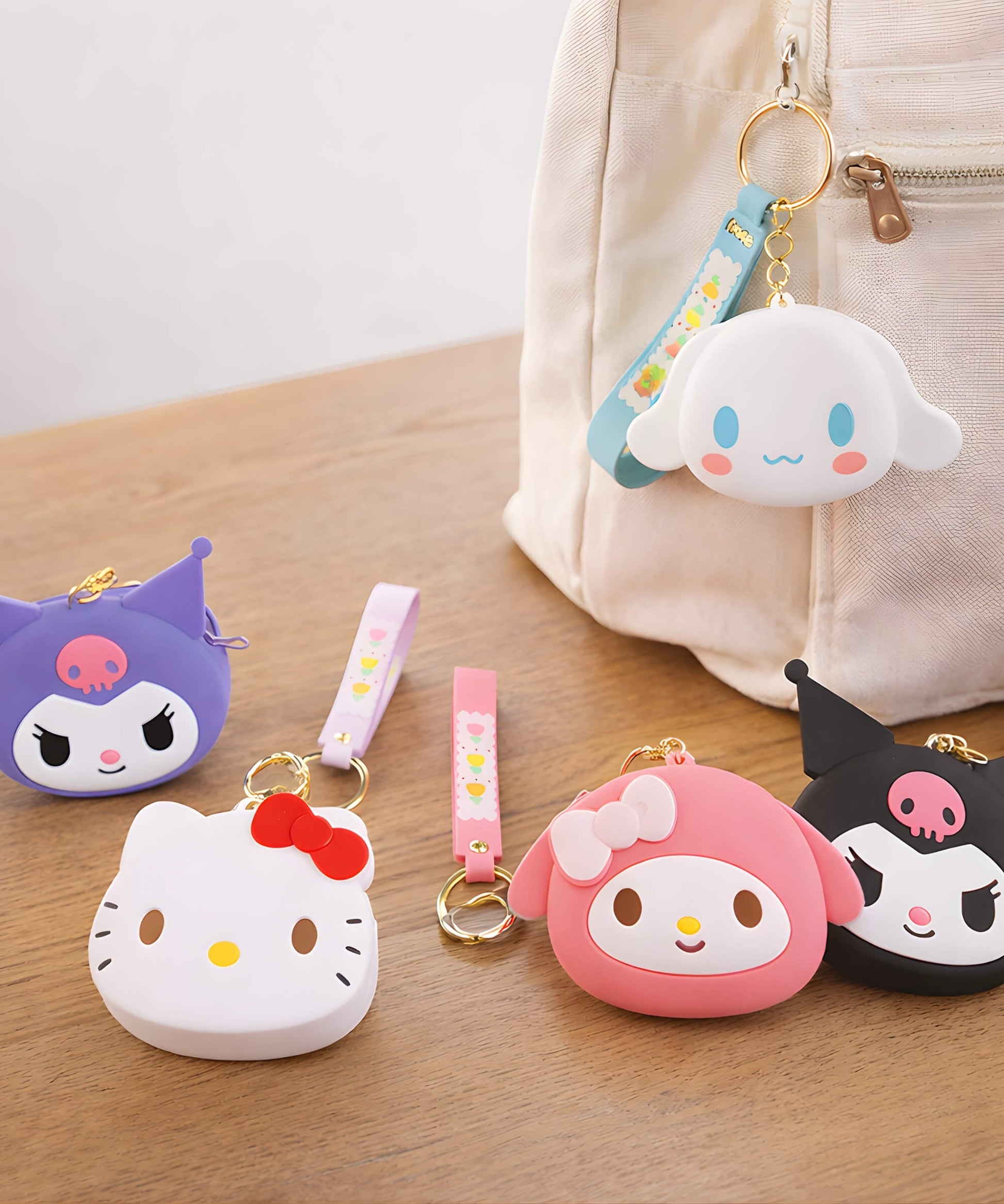 Sanrio silicone coin purse keychains attached to backpack and placed on table, Hello Kitty Kuromi My Melody Cinnamoroll