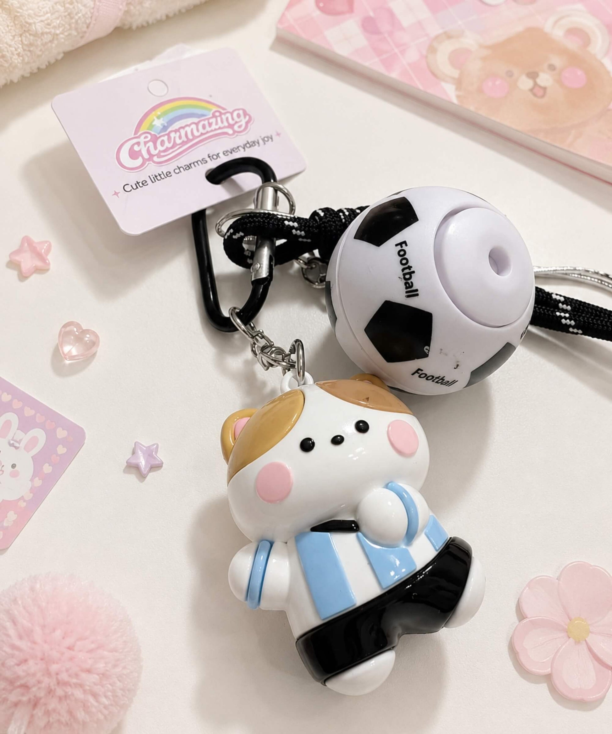 Soccer ball spinner keychain with blue team cat charm, rotating football detail and CHARMAZING packaging