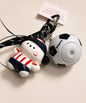 Close-up of red stripe dog soccer ball spinner keychain with football charm and rope-style strap
