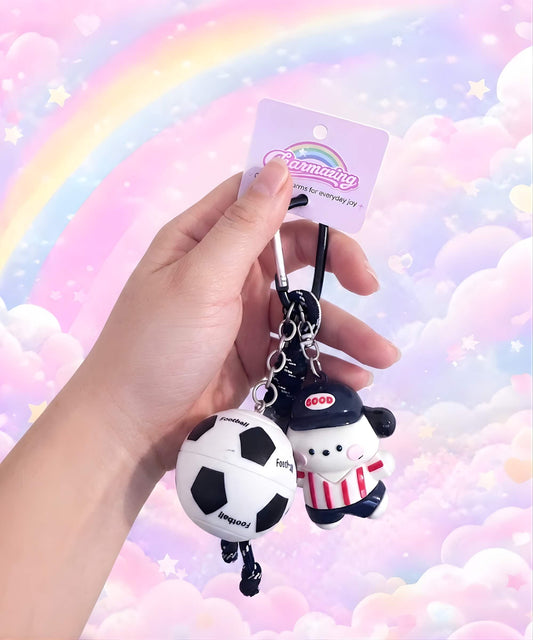 Red stripe dog soccer ball spinner keychain held in hand with football charm and CHARMAZING packaging