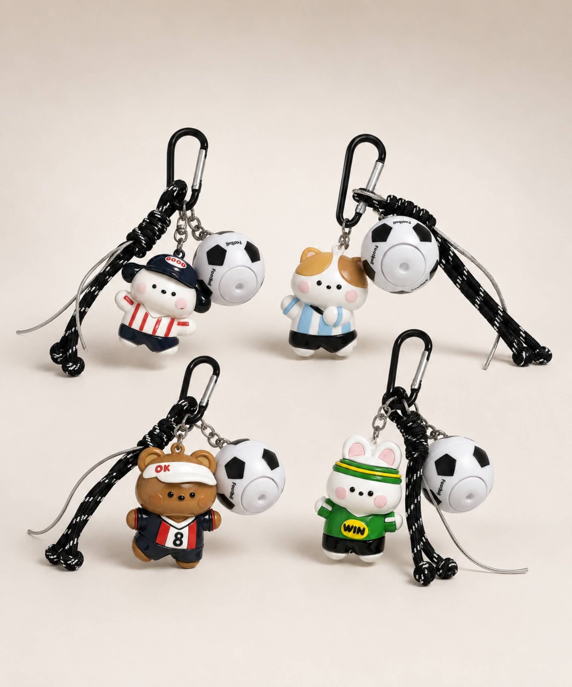 Soccer ball spinner keychains in four cute football-inspired character styles with rope-style straps