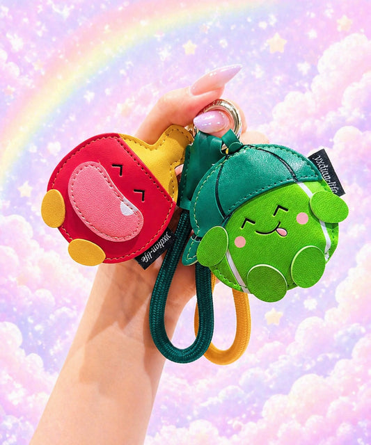 Tennis and table tennis PU leather bag charm keychains held against a pastel rainbow background.