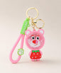 Strawberry Bear bead shaker keychain with pink strap and gold hardware on a neutral background